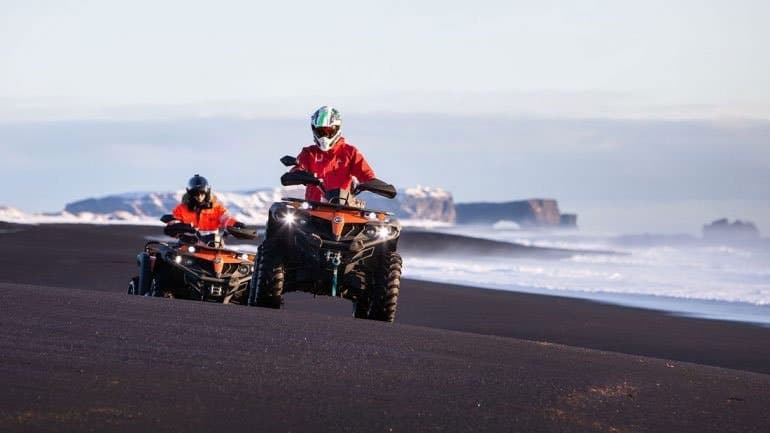 two ATV's on a black sand beach in the south of Iceland
