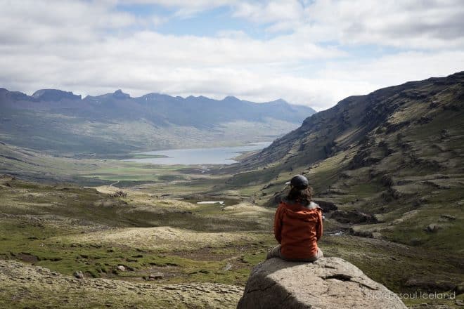 A man sitting on a ledge in the Icelandic Highlands.