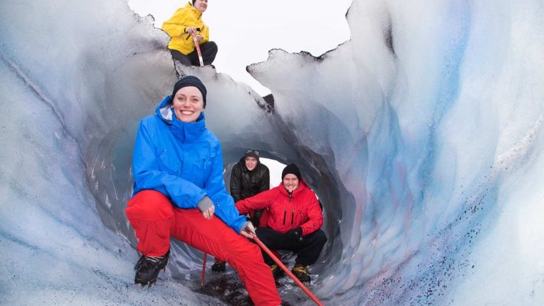 Glacier hikers exploring a crevasse in South Iceland