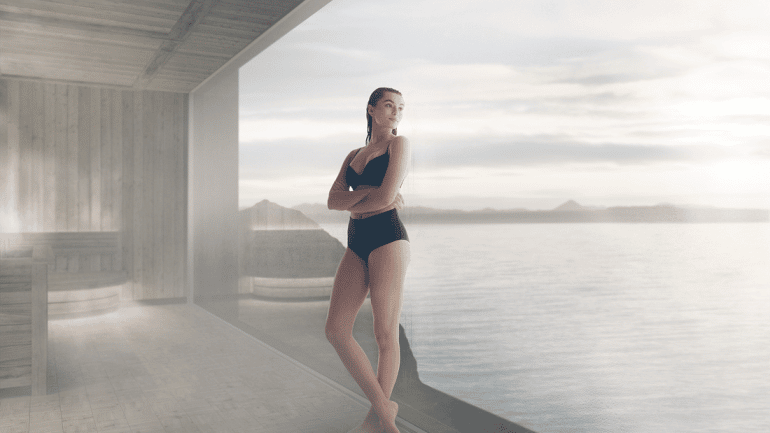 A woman standing in a sauna at the Sky Lagoon