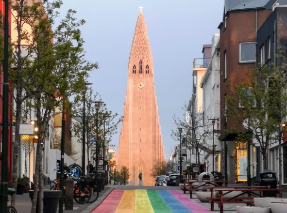Hallgrímskirkja Church in front of a rainbow-coloured street