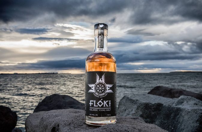 Icelandic whisky on dark rocks on a cloudy day.
