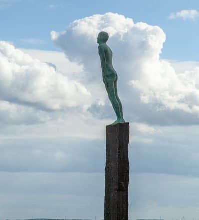 Statue of a man against a blue sky in Vik, Iceland